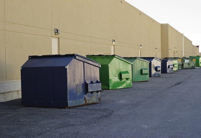 construction workers disposing of debris in large dumpsters in Ceres